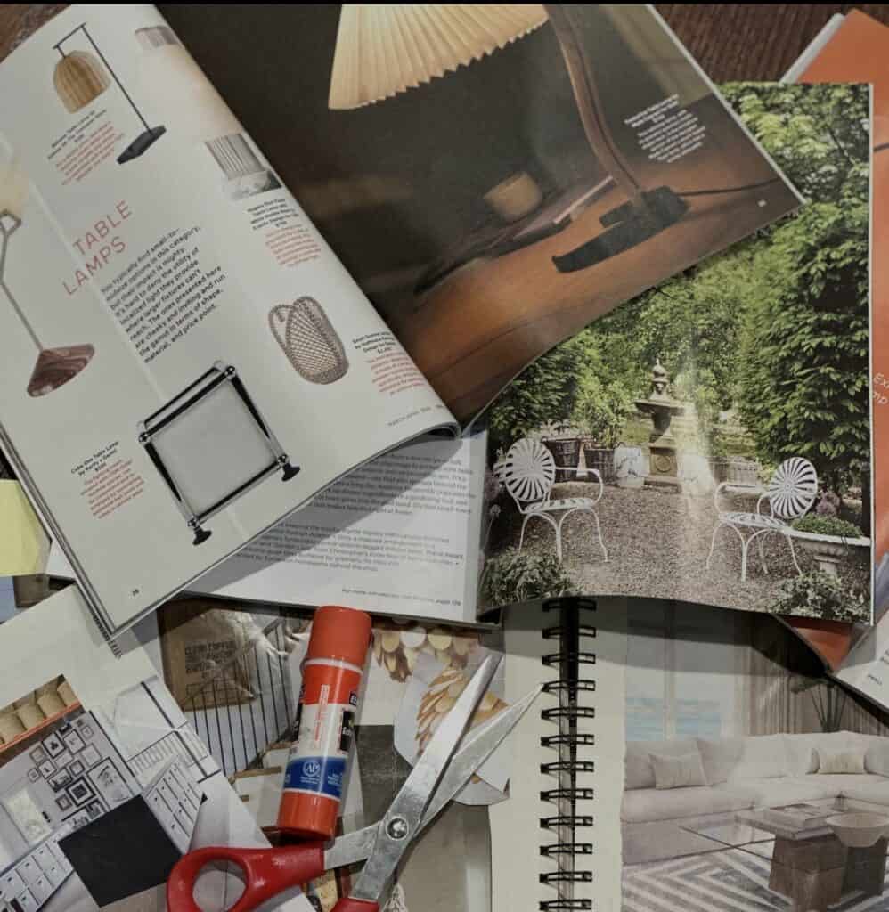 Magazine clippings, scissors, glue stick, and notebook used to create a handmade lookbook for tactile memory