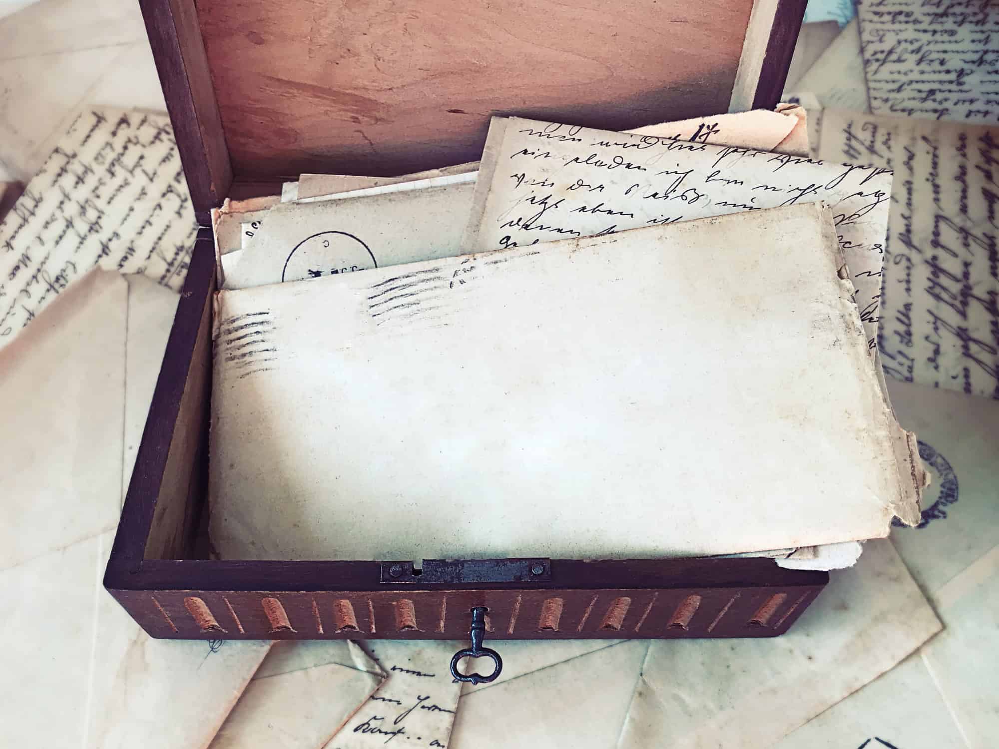 Stack of old letters in a wooden box