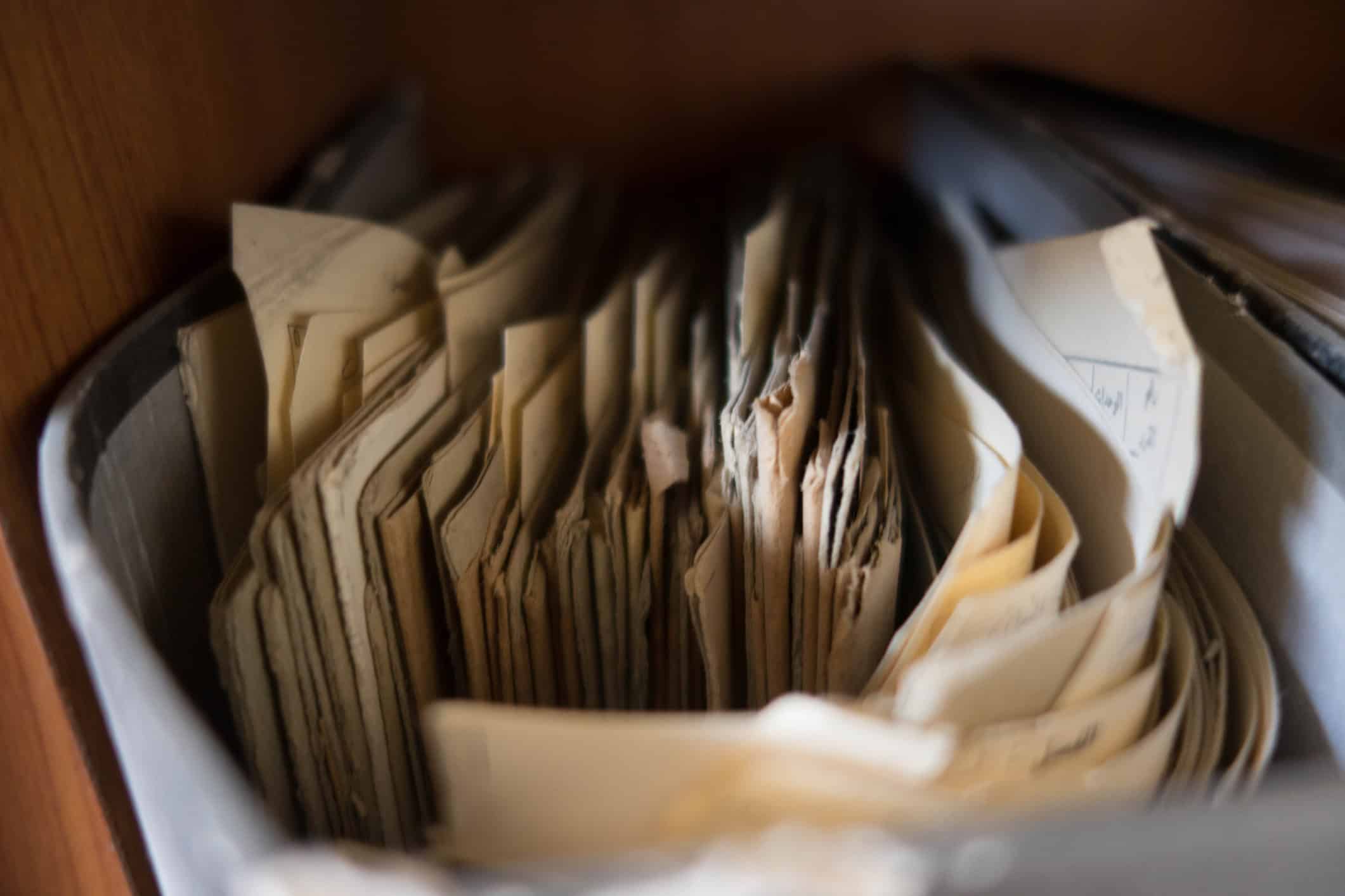 Old papers and folders stored in an archive box