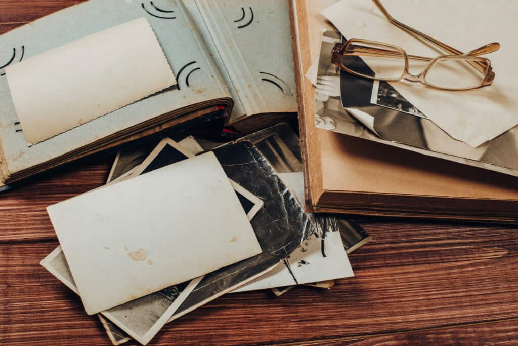 Old family photos and blank paper for creating a family memory journal