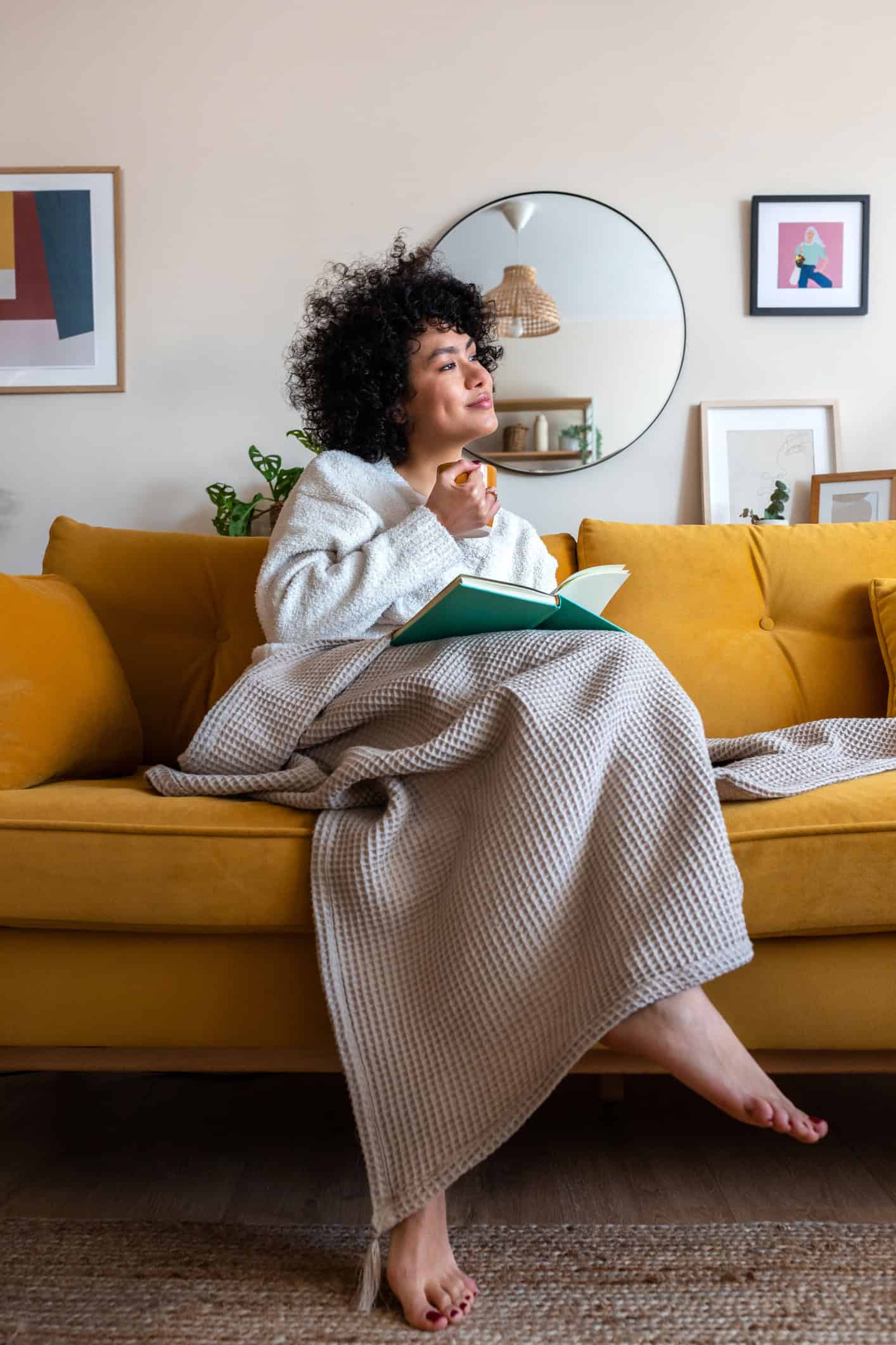 Woman reflecting on life lessons learned while writing in a notebook at home