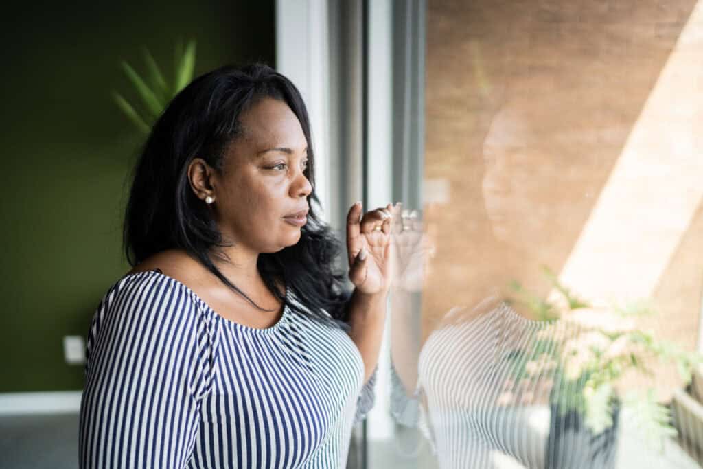 A woman reflecting on strengths that no longer serve you during a season of change